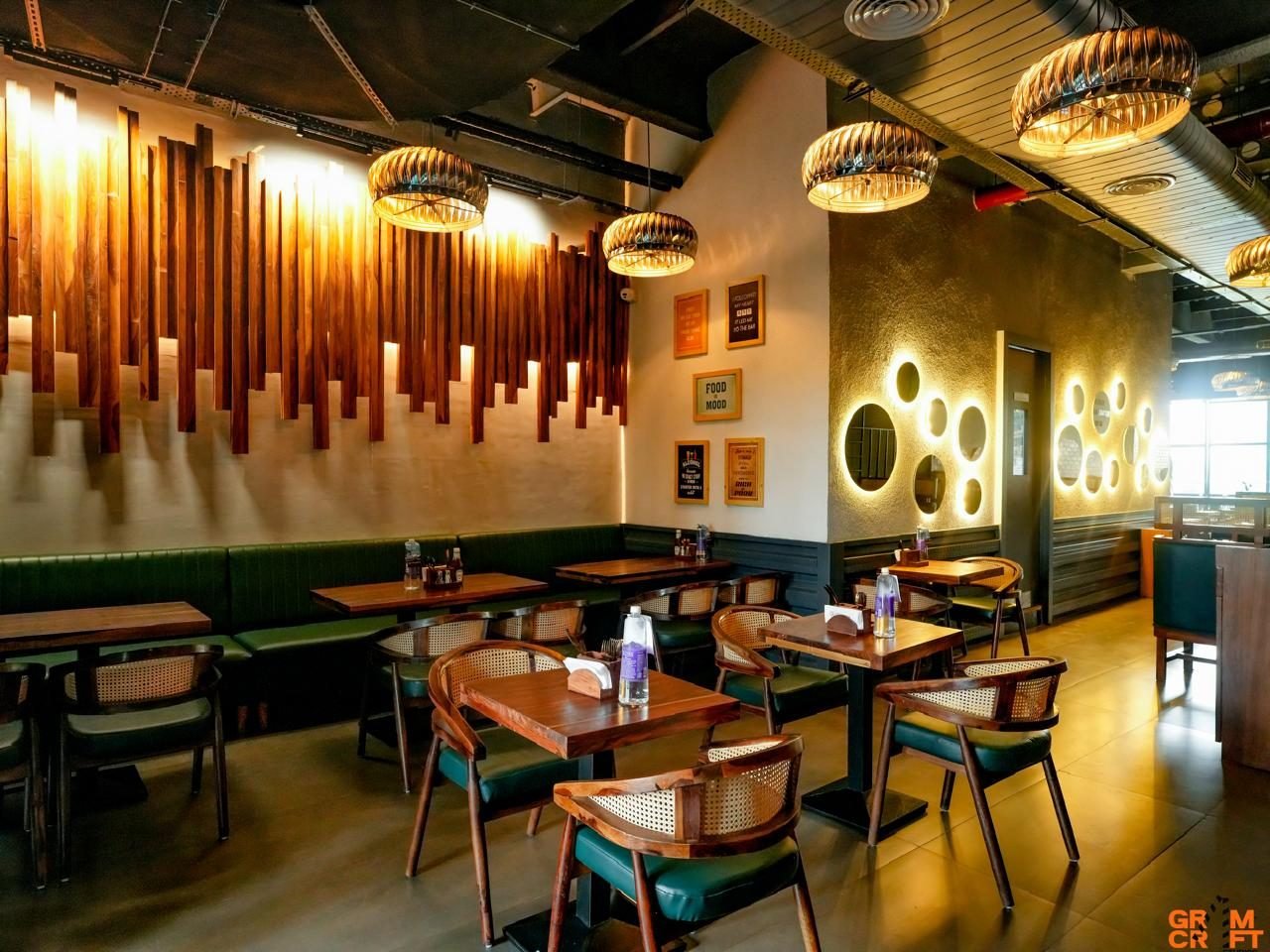 Dhamak cafe wood-slat feature wall and cane chairs, Greater Noida