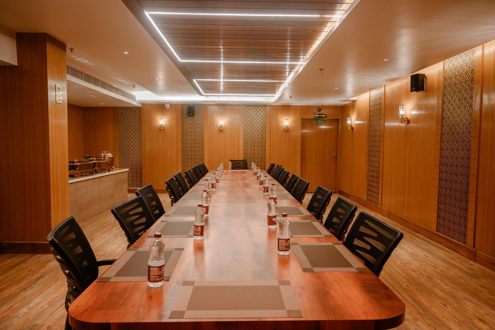 Custom-built long conference table and chairs by Venus Creatives